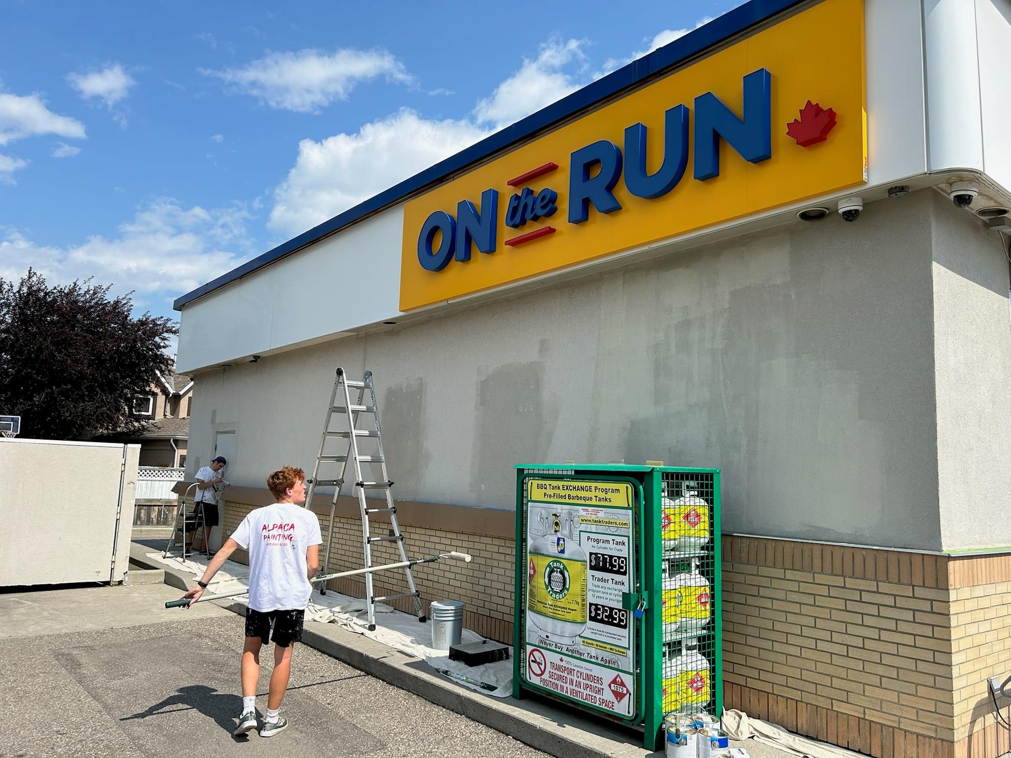 Alpaca Painting crew repainting the exterior wall of a commercial building