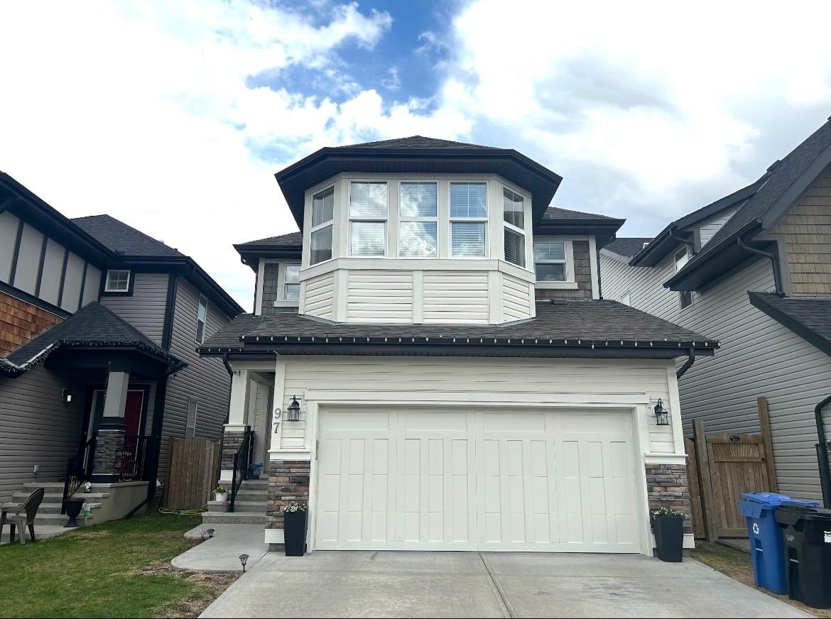 Two-storey home with white siding and dark painted trim