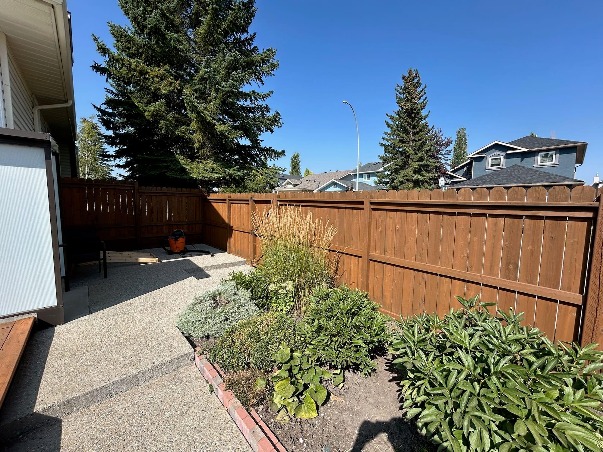 Stained backyard fence and patio