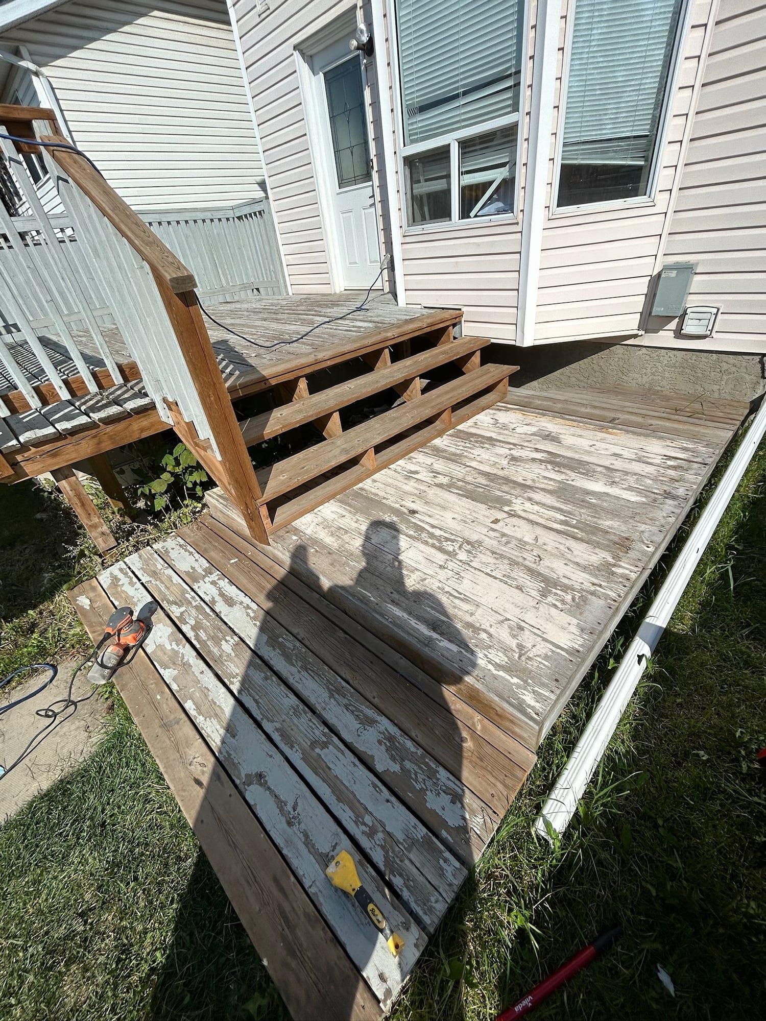 Deck boards and steps with old paint worn back and peeling