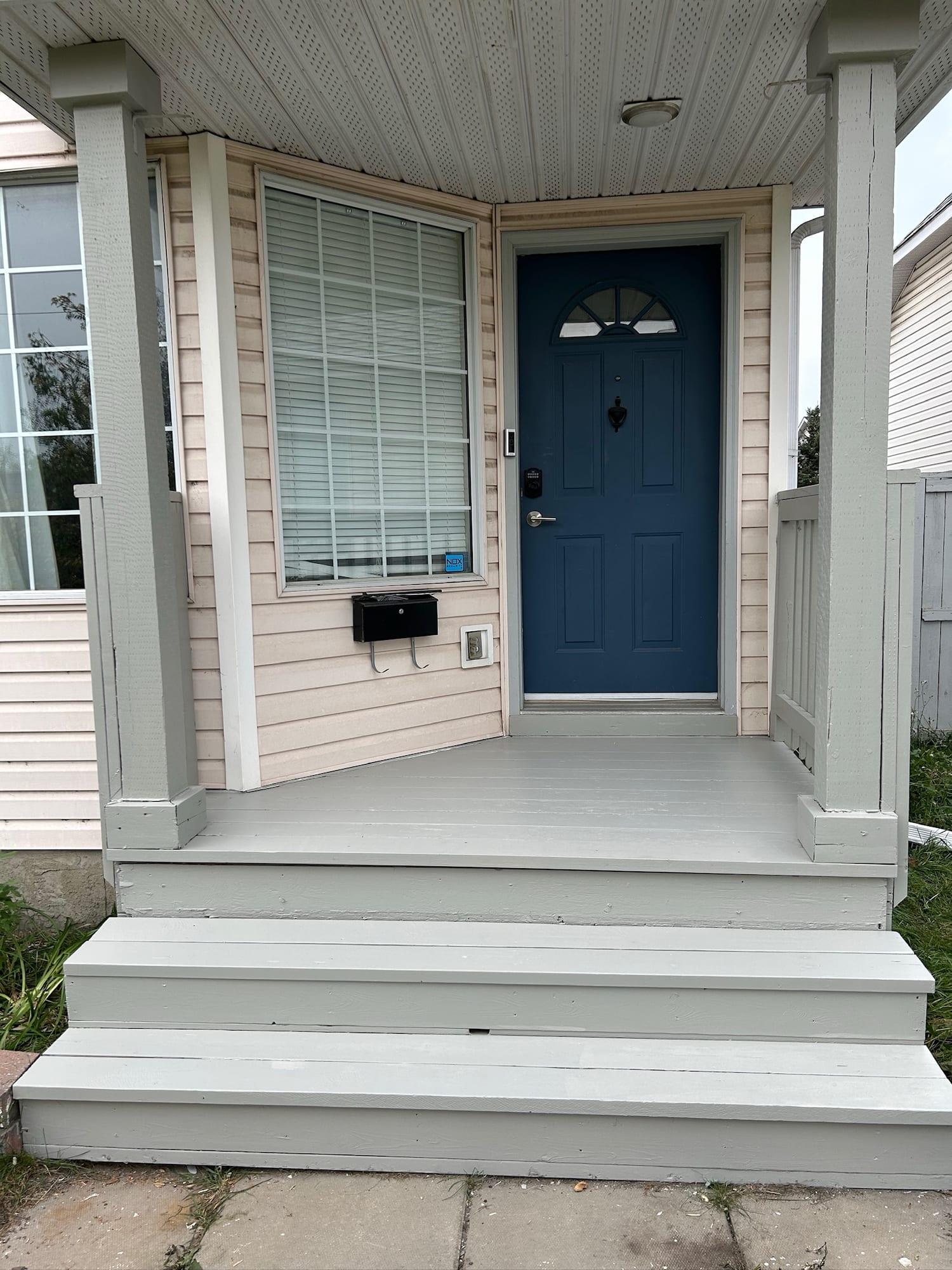 The same front porch and steps after preparation and repainting in grey