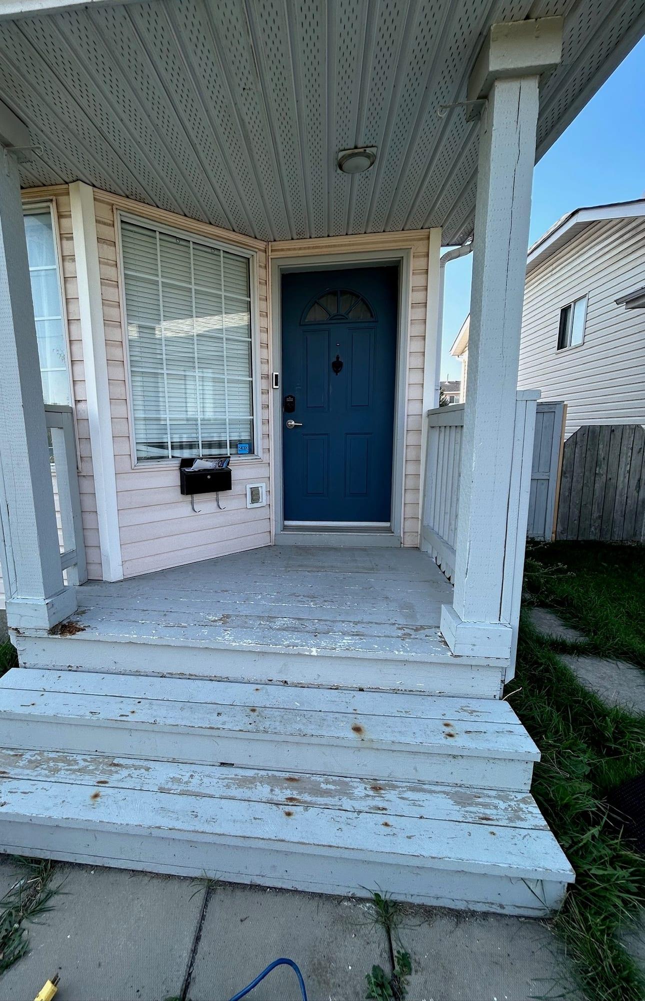 Front porch and steps with paint flaking away from the treads and landing