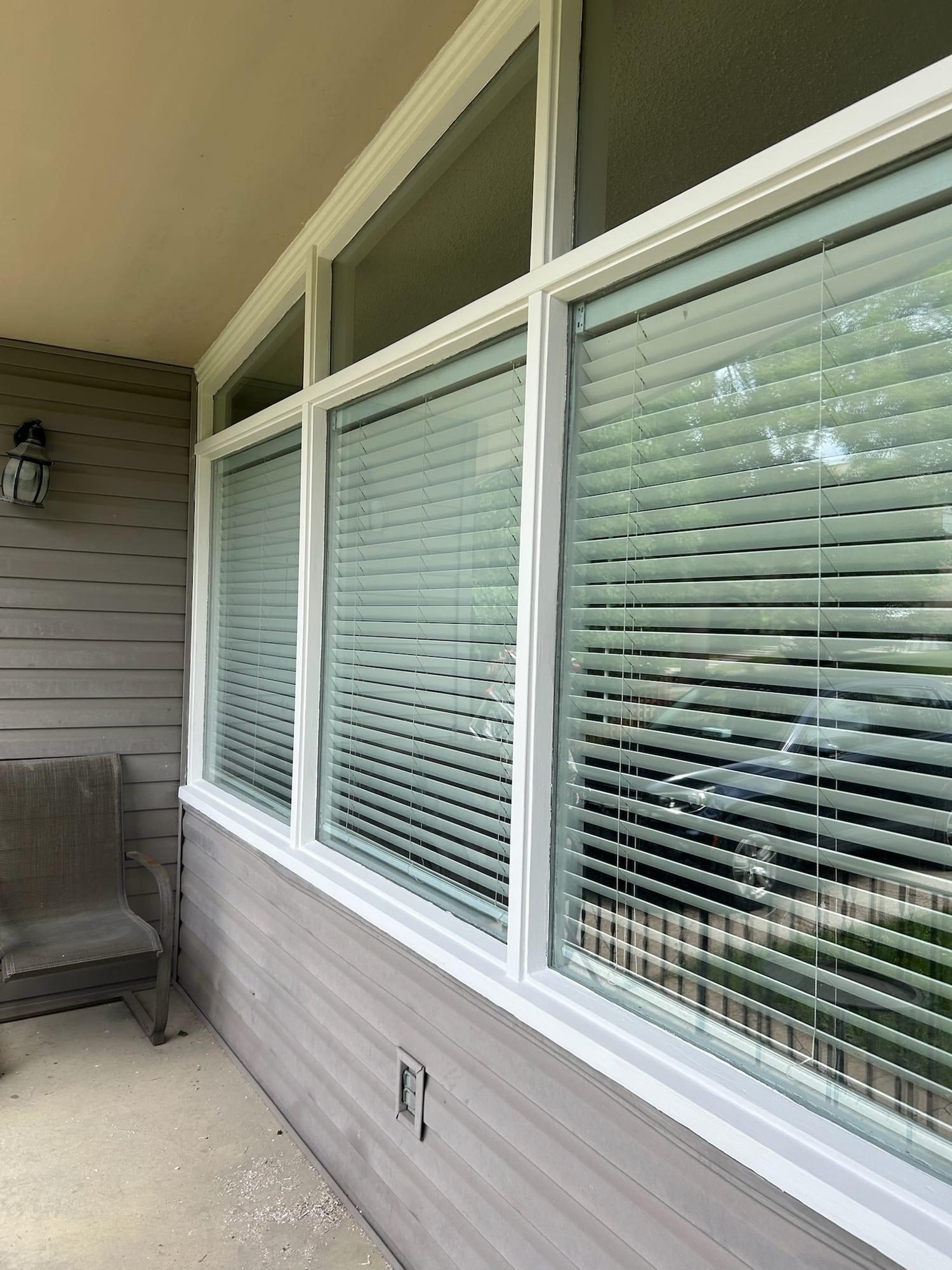 The same porch windows after preparation and repainting in white